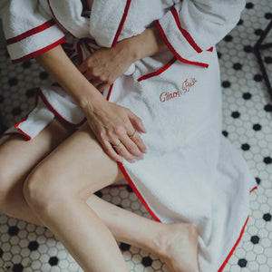 A closeup of the 'Ciao Bella' embroidery on The Happily Eva After Collection Roberta Bathrobe